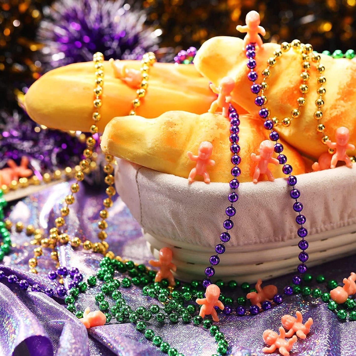 24 King Cake Babies in flesh  and 12 purple green and gold metallic finish beads Party Parade Masquerade